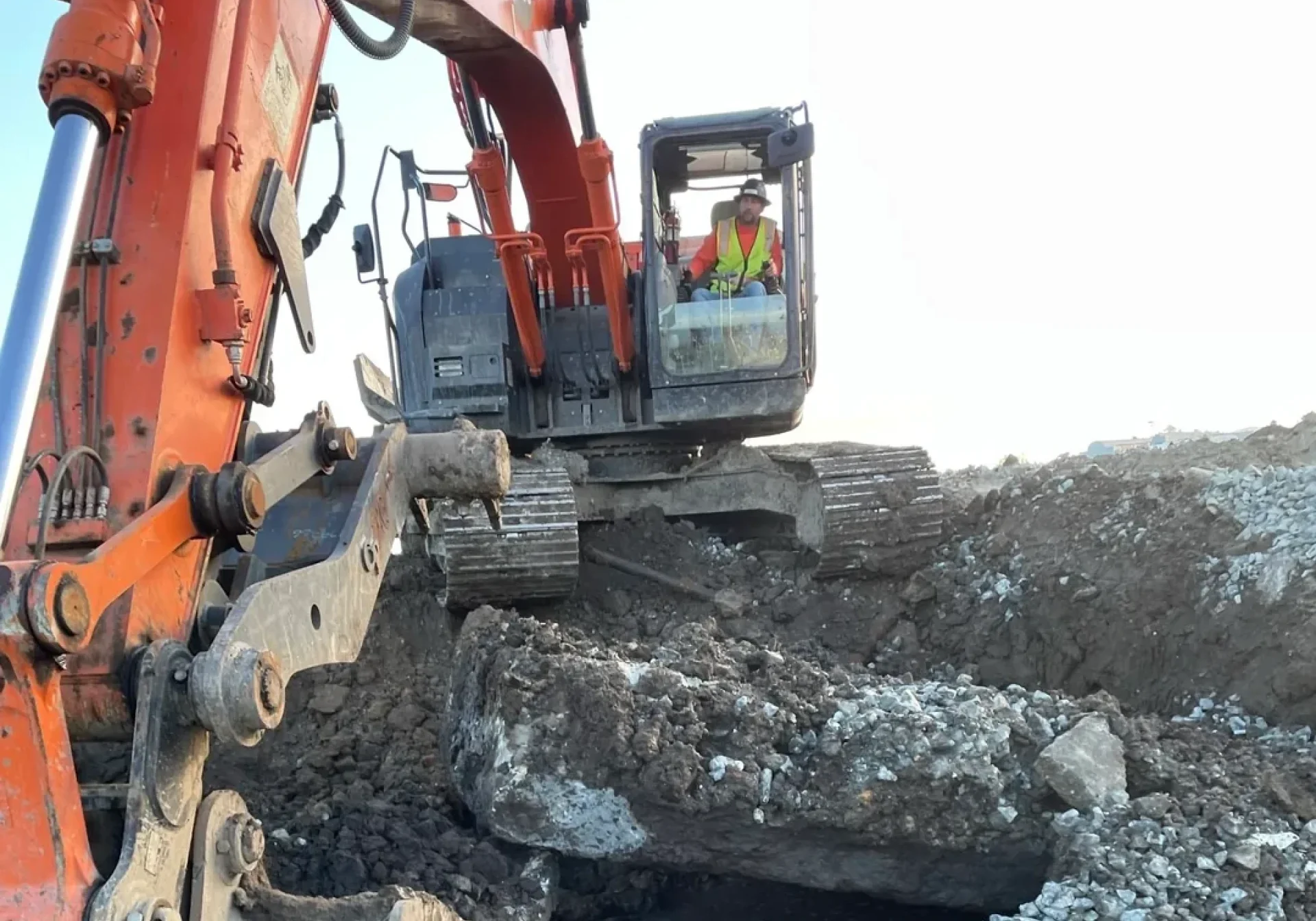 Construction worker operating excavator